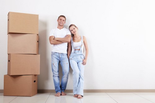 Removal team planning a safe moving job with packed items and equipment