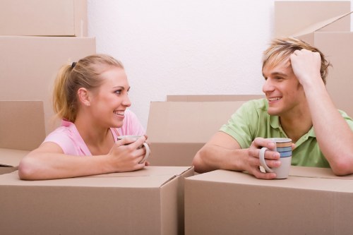 House removalists loading boxes into a moving van in London