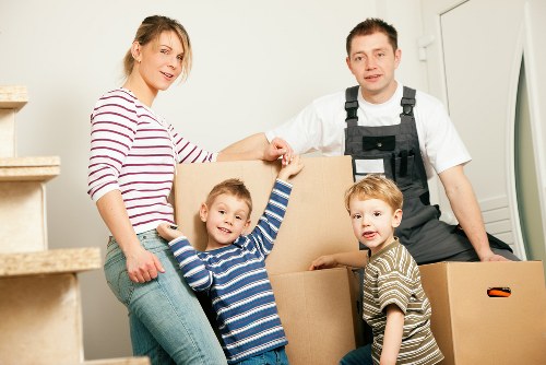 Professional movers packing furniture for a London house move