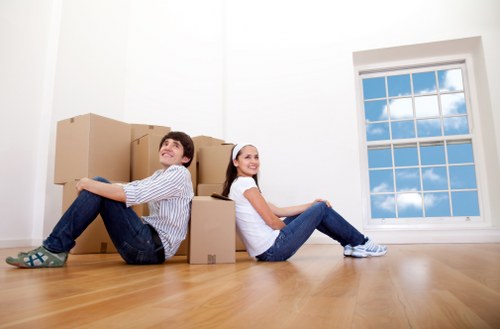 London removals team carefully packing fragile items for transport