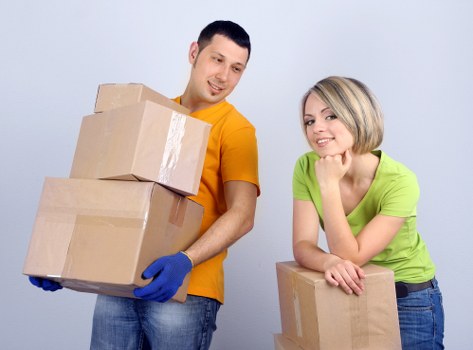 Experienced movers loading furniture for a London house move