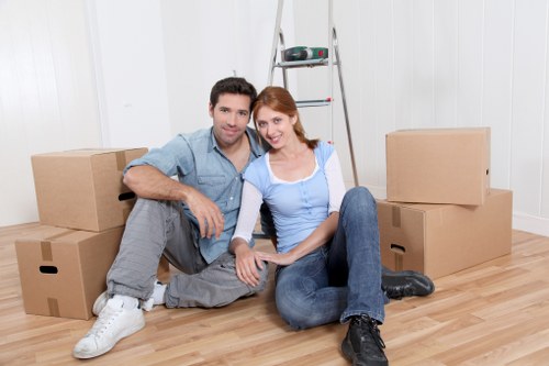 Movers unpacking household items in a London property after relocation