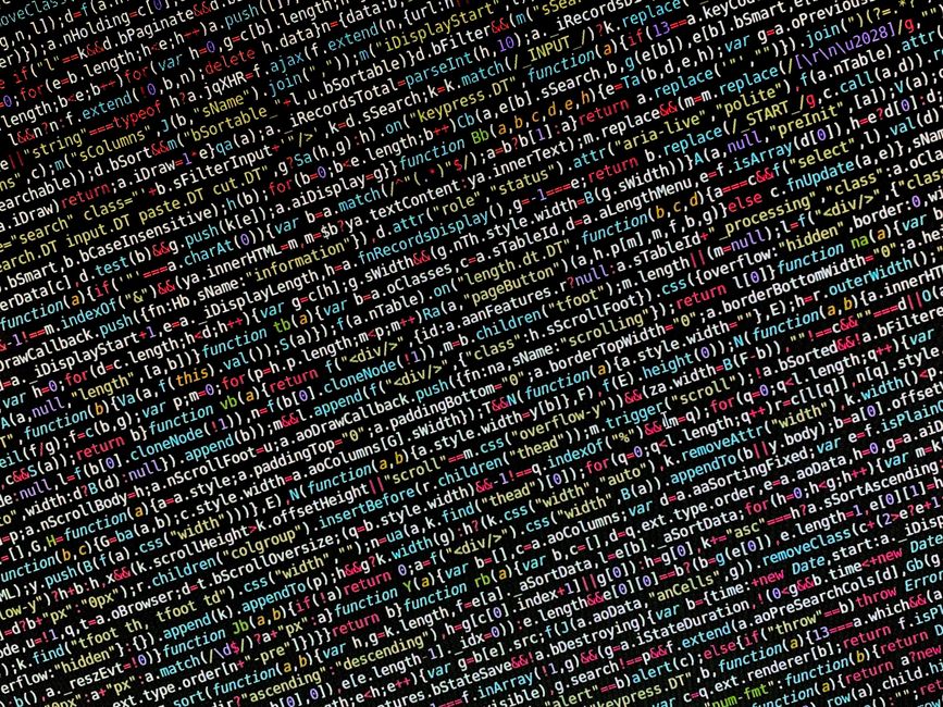 Close-up of a computer screen displaying complex lines of HTML and JavaScript code with highlighted functions and tags in multiple colors. The code features various elements related to webpage structu